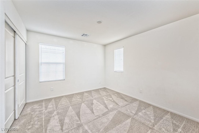 156 Fulgora St, Henderson, NV 89074 - unfurnished bedroom featuring multiple windows, visible vents, and light colored carpet