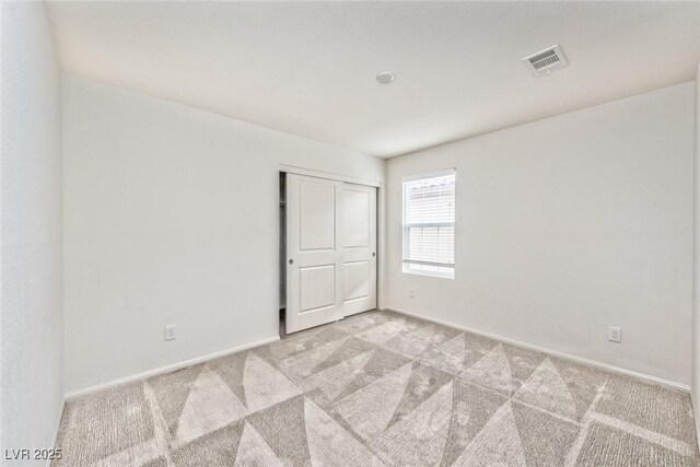 156 Fulgora St, Henderson, NV 89074 - empty room featuring light colored carpet, baseboards, and visible vents