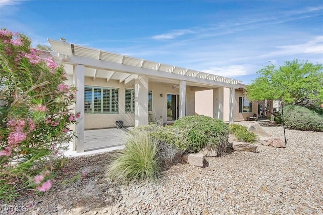 2525 Willow Wren Dr, North Las Vegas, NV 89084 - back of house with stucco siding and a pergola