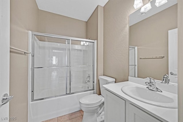 2525 Willow Wren Dr, North Las Vegas, NV 89084 - bathroom featuring toilet, vanity, combined bath / shower with glass door, tile patterned floors, and a textured wall