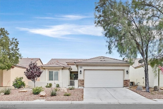 2525 Willow Wren Dr, North Las Vegas, NV 89084 - view of front of property featuring a garage, concrete driveway, stone siding, stucco siding, and a tile roof