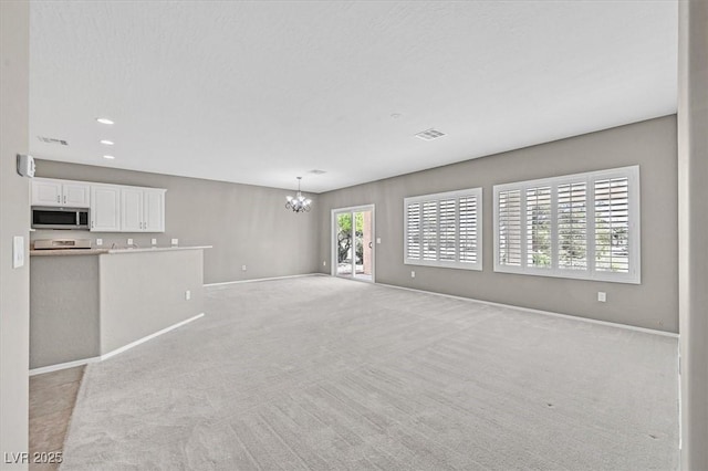 2525 Willow Wren Dr, North Las Vegas, NV 89084 - unfurnished living room with a chandelier, light carpet, baseboards, and recessed lighting