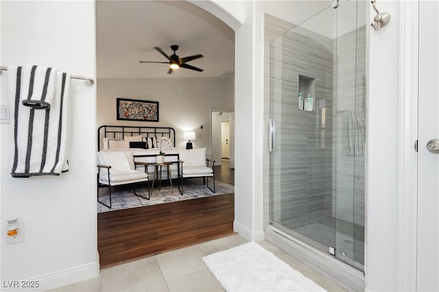 bathroom with tile patterned floors, baseboards, a shower stall, and a ceiling fan