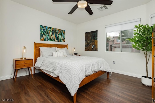 bedroom featuring baseboards, ceiling fan, wood finished floors, and visible vents