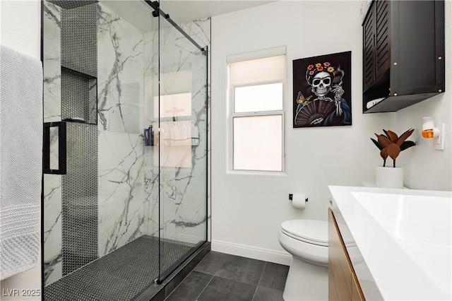 bathroom featuring a marble finish shower, baseboards, vanity, and toilet