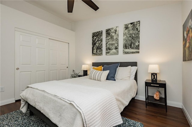 bedroom featuring a ceiling fan, baseboards, dark wood finished floors, and a closet