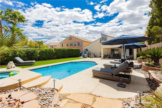 view of swimming pool with a fenced in pool, fence, and a patio