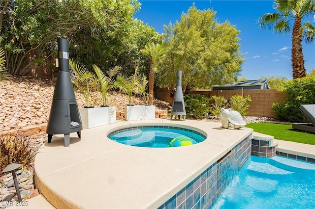 view of pool with an in ground hot tub, fence, and a fenced in pool