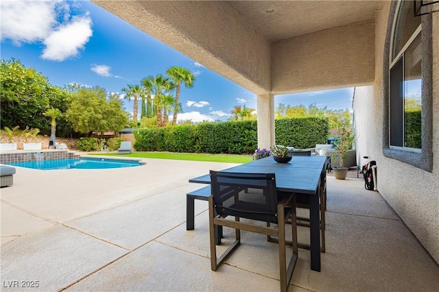 view of patio with a fenced in pool and outdoor dining space