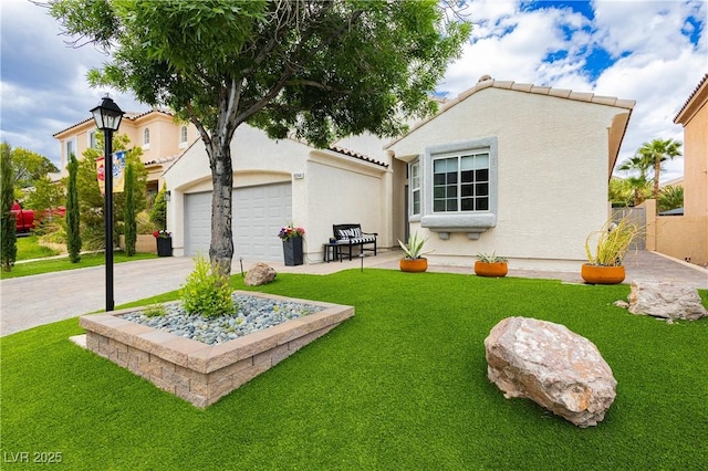 rear view of property with a garage, stucco siding, and a yard