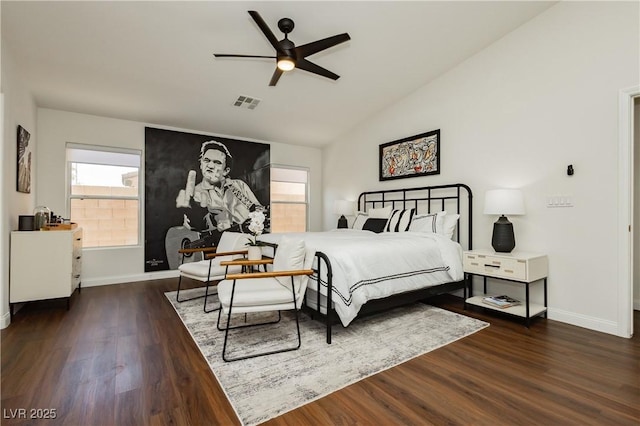 bedroom featuring visible vents, baseboards, wood finished floors, and vaulted ceiling