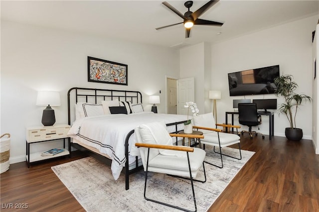 bedroom with baseboards and wood finished floors
