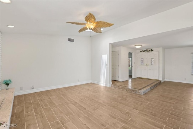 interior space with a ceiling fan, visible vents, baseboards, light wood-style floors, and recessed lighting
