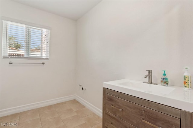 bathroom with baseboards and vanity
