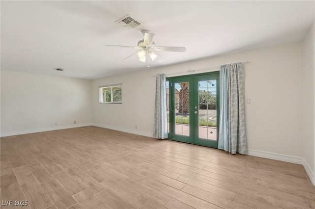 unfurnished room with ceiling fan, visible vents, french doors, and light wood finished floors