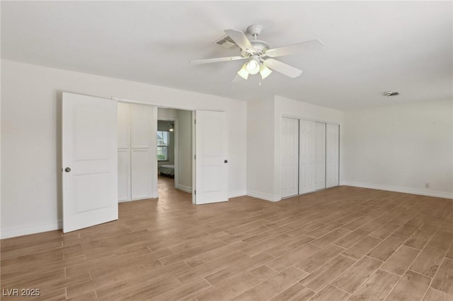 unfurnished bedroom with baseboards, a closet, and light wood-style flooring