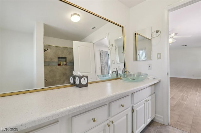 bathroom with vanity, tile patterned flooring, a ceiling fan, and visible vents