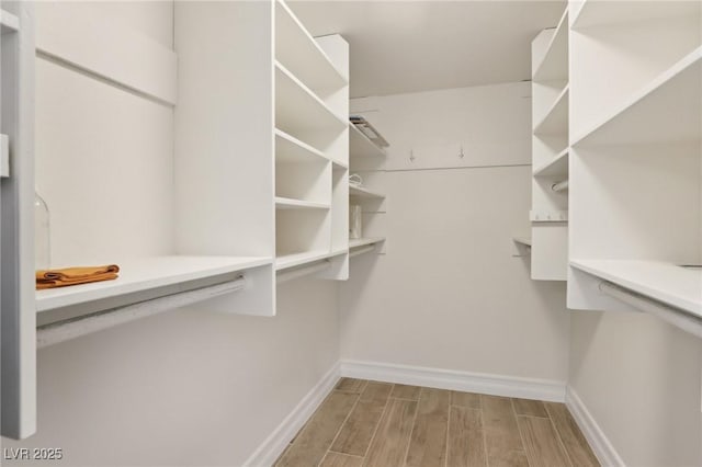 spacious closet with wood finished floors