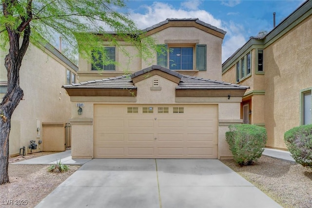 view of front facade featuring an attached garage, stucco siding, driveway, and a tile roof