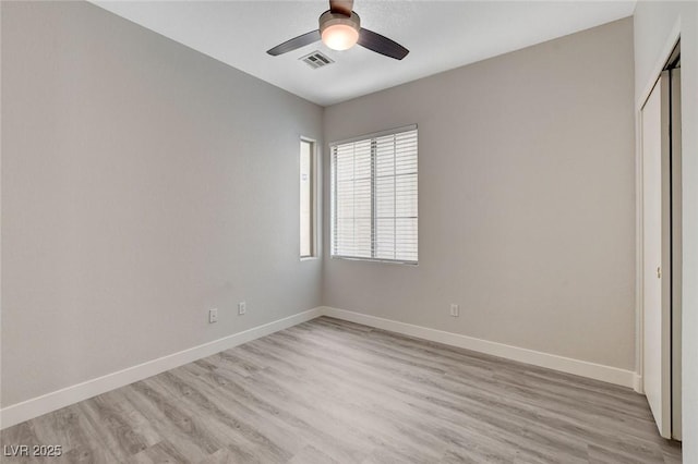 unfurnished bedroom featuring light wood-style floors, baseboards, visible vents, and a closet