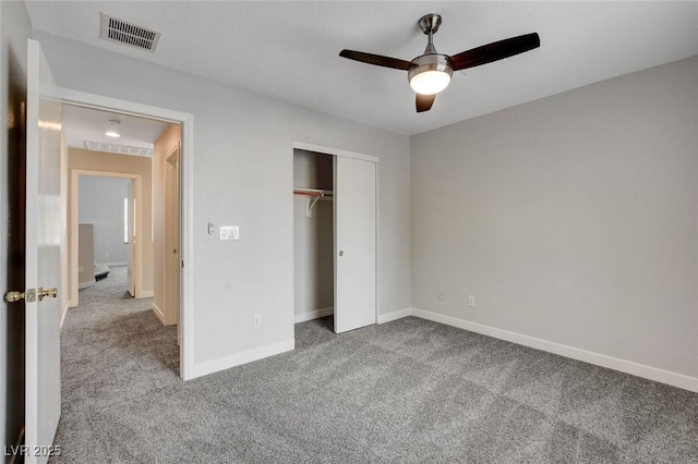 unfurnished bedroom featuring visible vents, a closet, baseboards, ceiling fan, and carpet