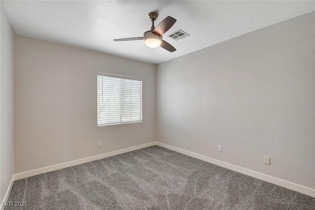 unfurnished room featuring a ceiling fan, baseboards, visible vents, and dark carpet