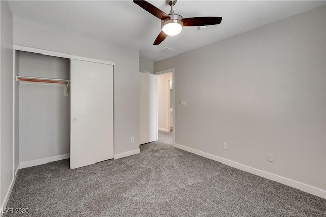 unfurnished bedroom featuring carpet flooring, baseboards, ceiling fan, and a closet