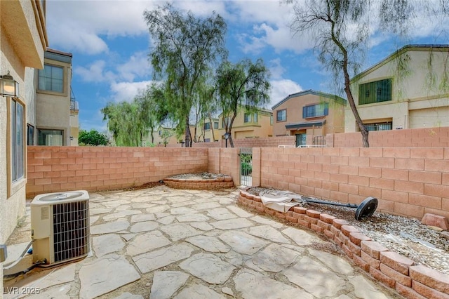 view of patio / terrace featuring a fenced backyard, central air condition unit, and a residential view