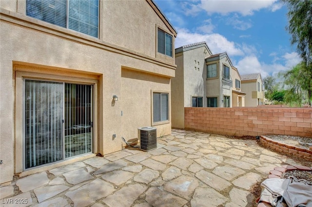 view of patio / terrace with fence and cooling unit