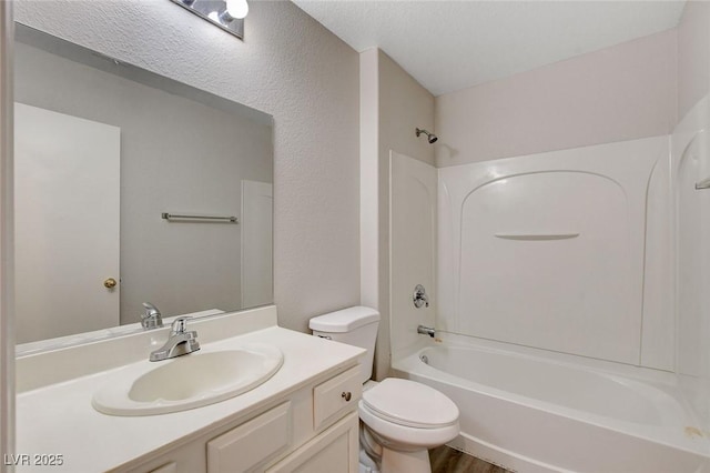 full bath featuring vanity, toilet, wood finished floors, and tub / shower combination