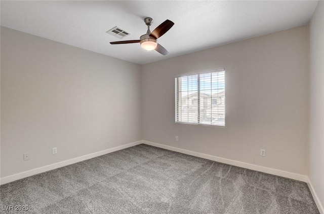 unfurnished room with visible vents, a ceiling fan, carpet, and baseboards