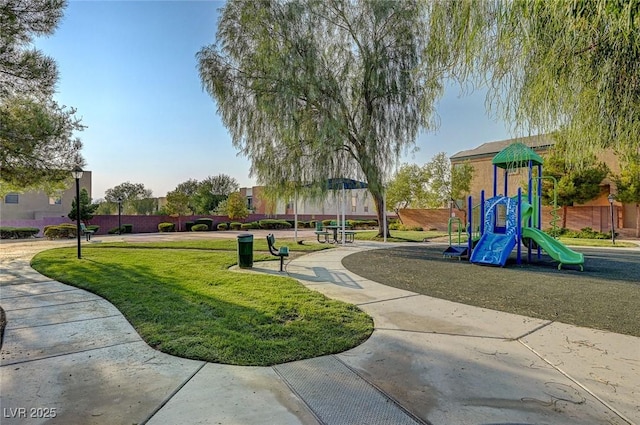community jungle gym featuring a lawn