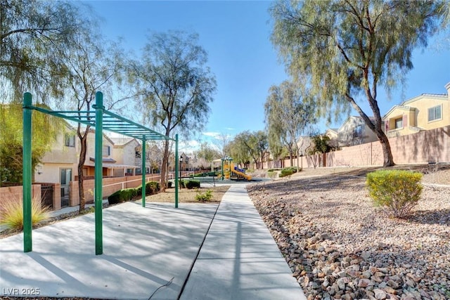 surrounding community featuring fence, a residential view, and playground community