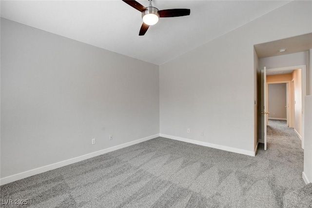 carpeted empty room with ceiling fan and baseboards