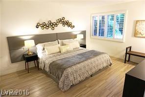 bedroom with baseboards and wood finished floors