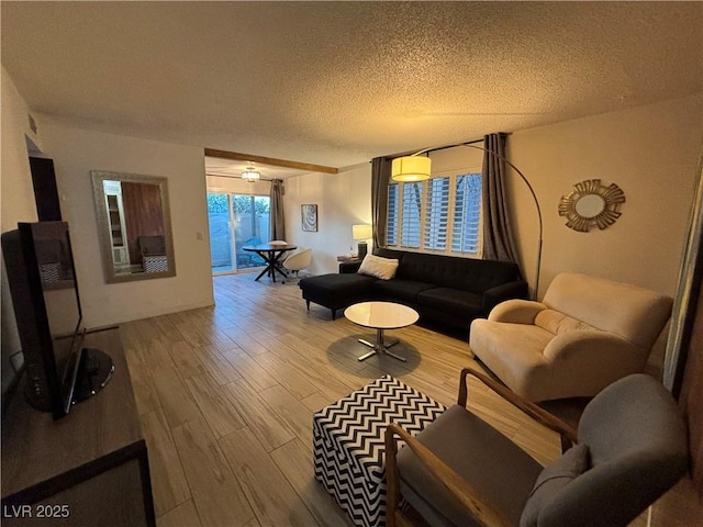 living area with a textured ceiling and wood finished floors