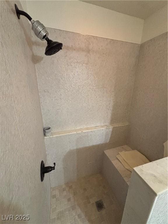 full bath with a tile shower