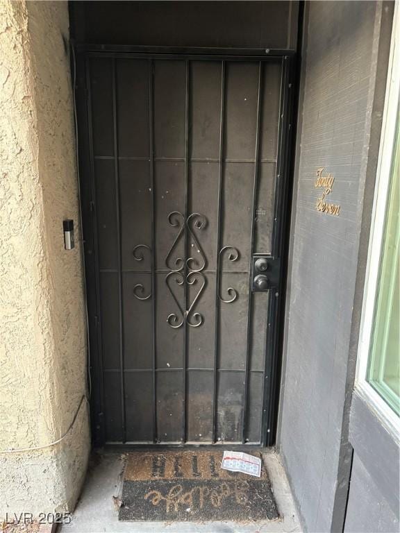 doorway to property featuring stucco siding