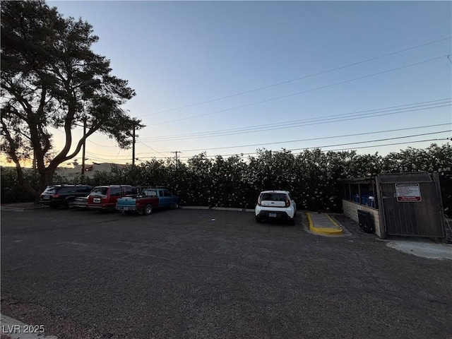 parking at dusk featuring uncovered parking