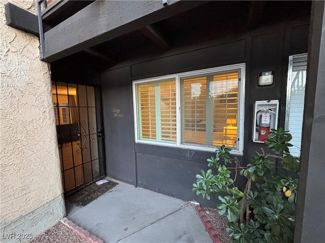property entrance with stucco siding