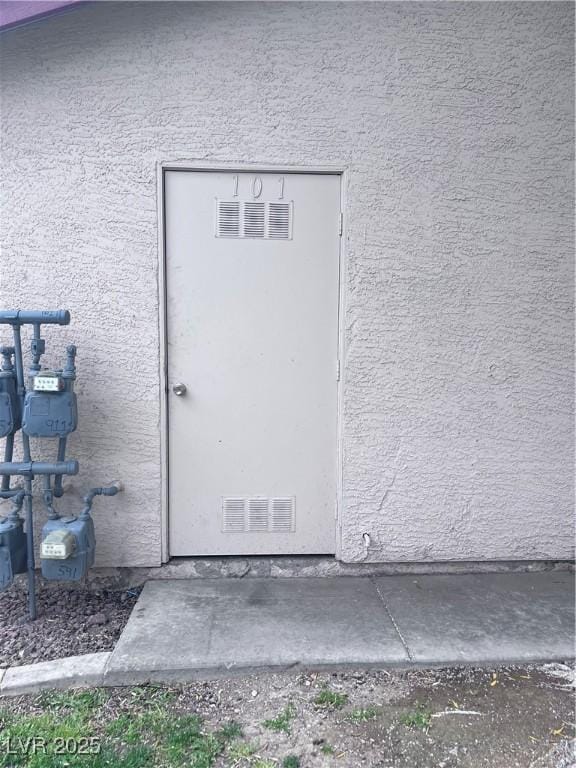 805 Rock Springs Dr Unit 101, Las Vegas, NV 89128 - doorway to property featuring stucco siding and visible vents