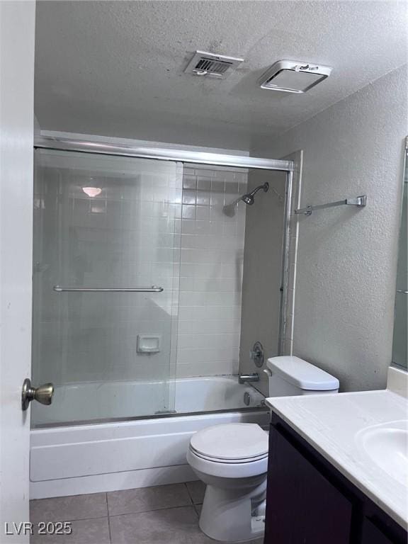 805 Rock Springs Dr Unit 101, Las Vegas, NV 89128 - full bathroom featuring toilet, vanity, a textured ceiling, visible vents, and tile patterned floors