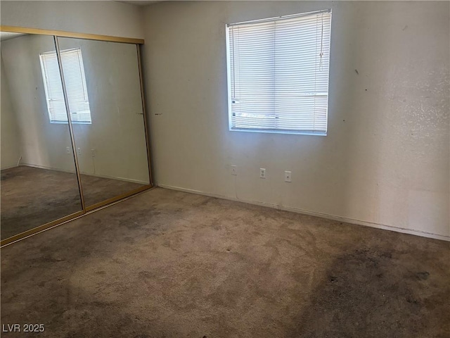 805 Rock Springs Dr Unit 101, Las Vegas, NV 89128 - unfurnished bedroom featuring carpet flooring and a closet