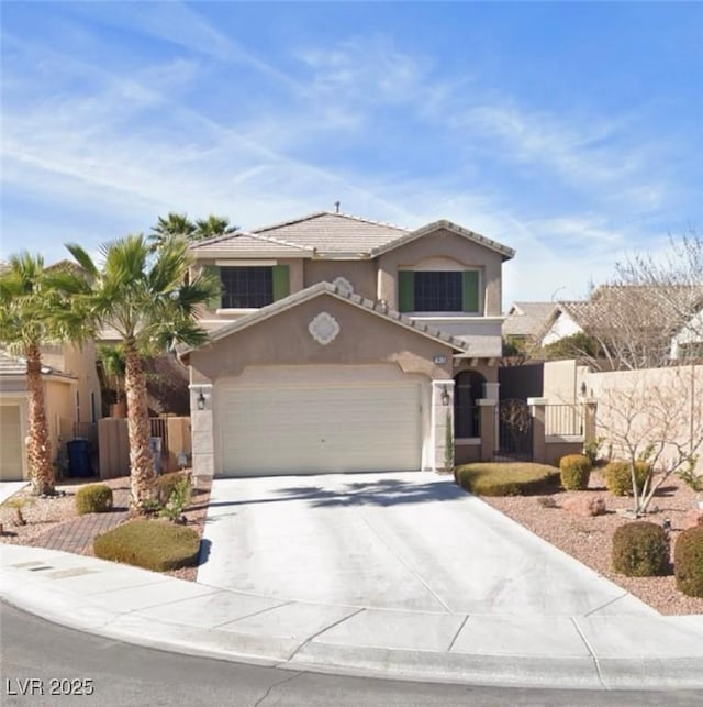 view of front of home featuring concrete driveway, a garage, fence, and stucco siding