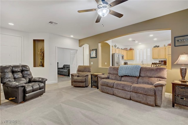 7013 Bisoni St, Las Vegas, NV 89149 - living area featuring arched walkways, light colored carpet, ceiling fan, recessed lighting, and baseboards