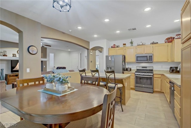 7013 Bisoni St, Las Vegas, NV 89149 - dining room with arched walkways, light tile patterned flooring, recessed lighting, and ceiling fan