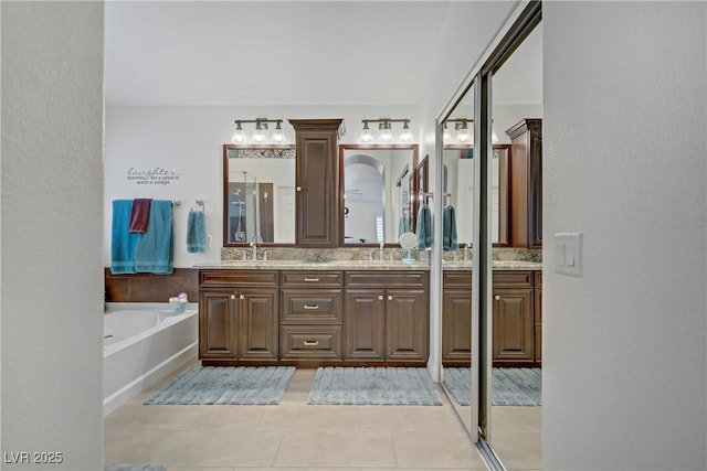 7013 Bisoni St, Las Vegas, NV 89149 - bathroom featuring tile patterned floors, double vanity, a bath, and a shower stall
