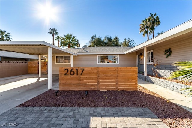 exterior space featuring fence and a carport