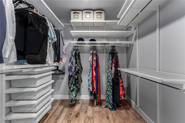 spacious closet with wood finished floors
