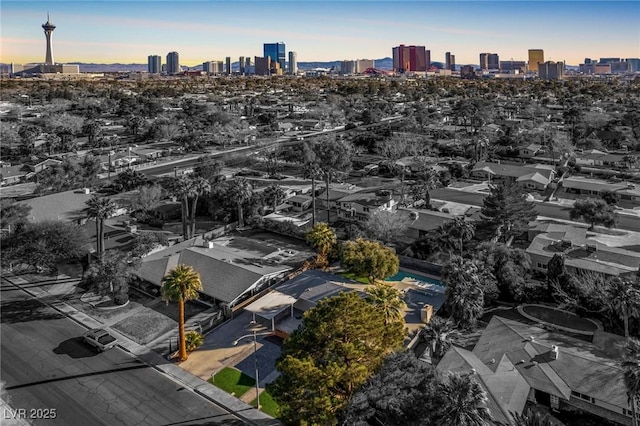 aerial view at dusk featuring a city view